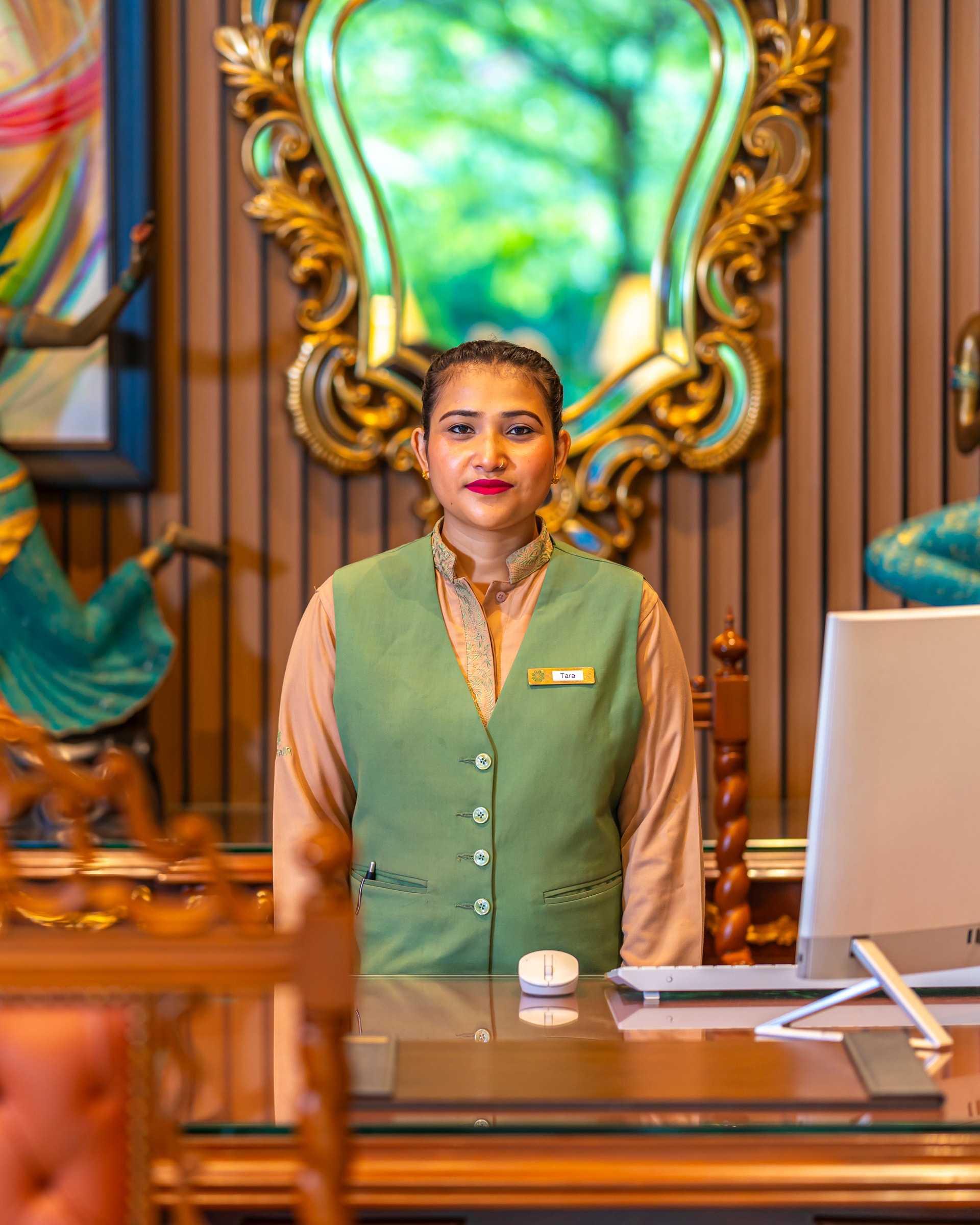 A front office associate at the reception desk