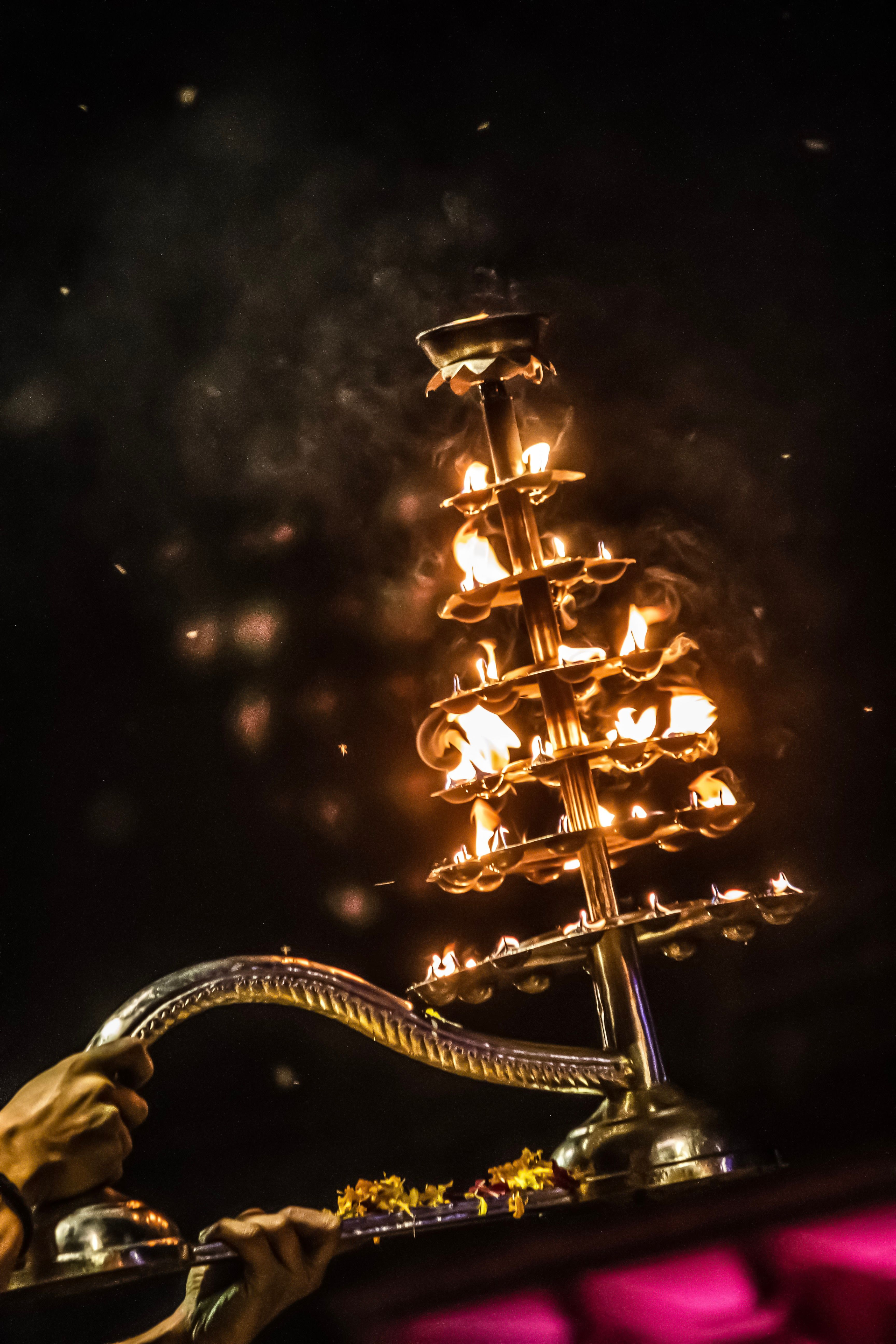 The aarti lamp lit at the water’s edge