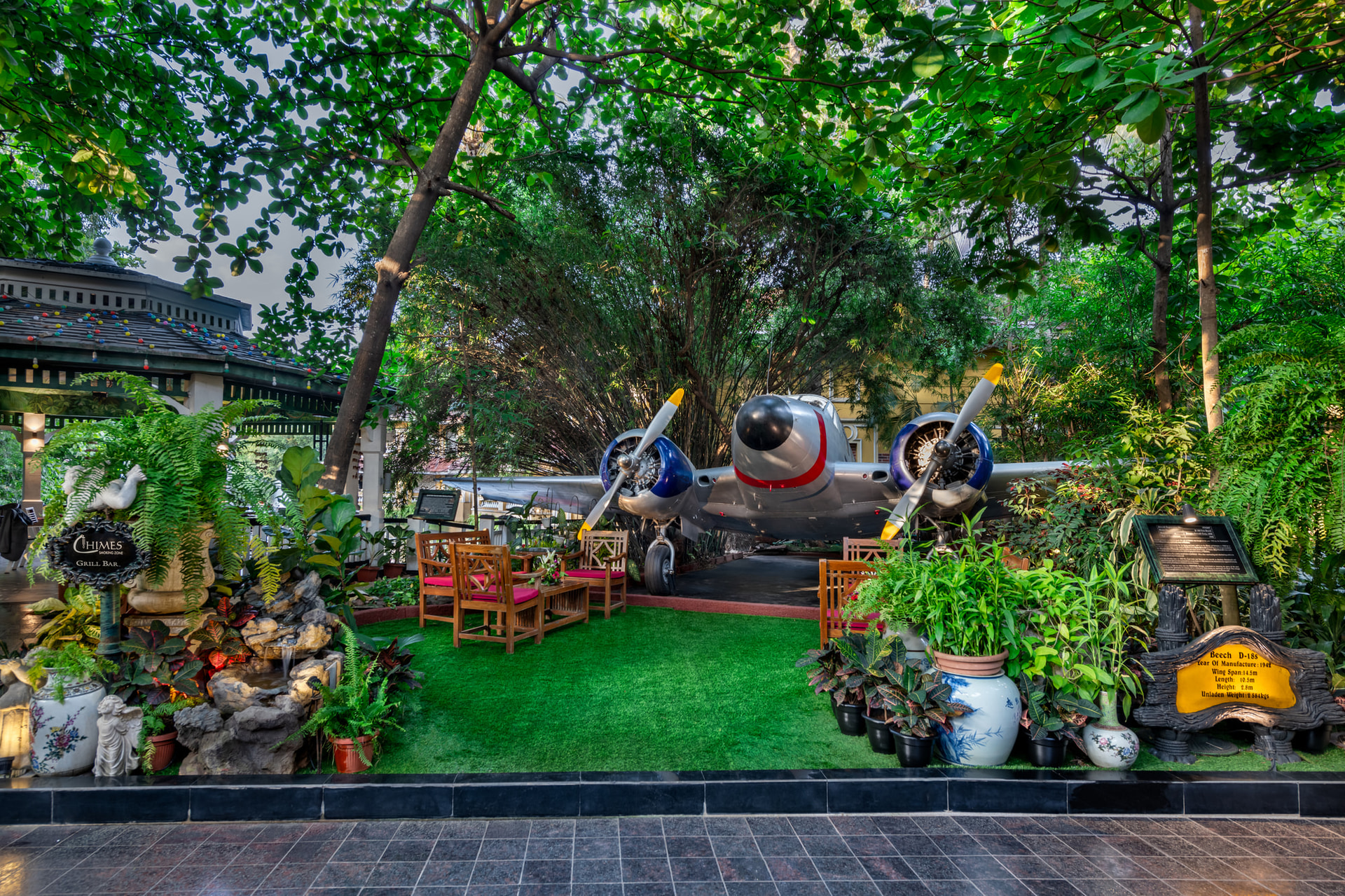 Lush green garden with golden Buddha sculpture and tropical landscaping at Mayfair Lagoon