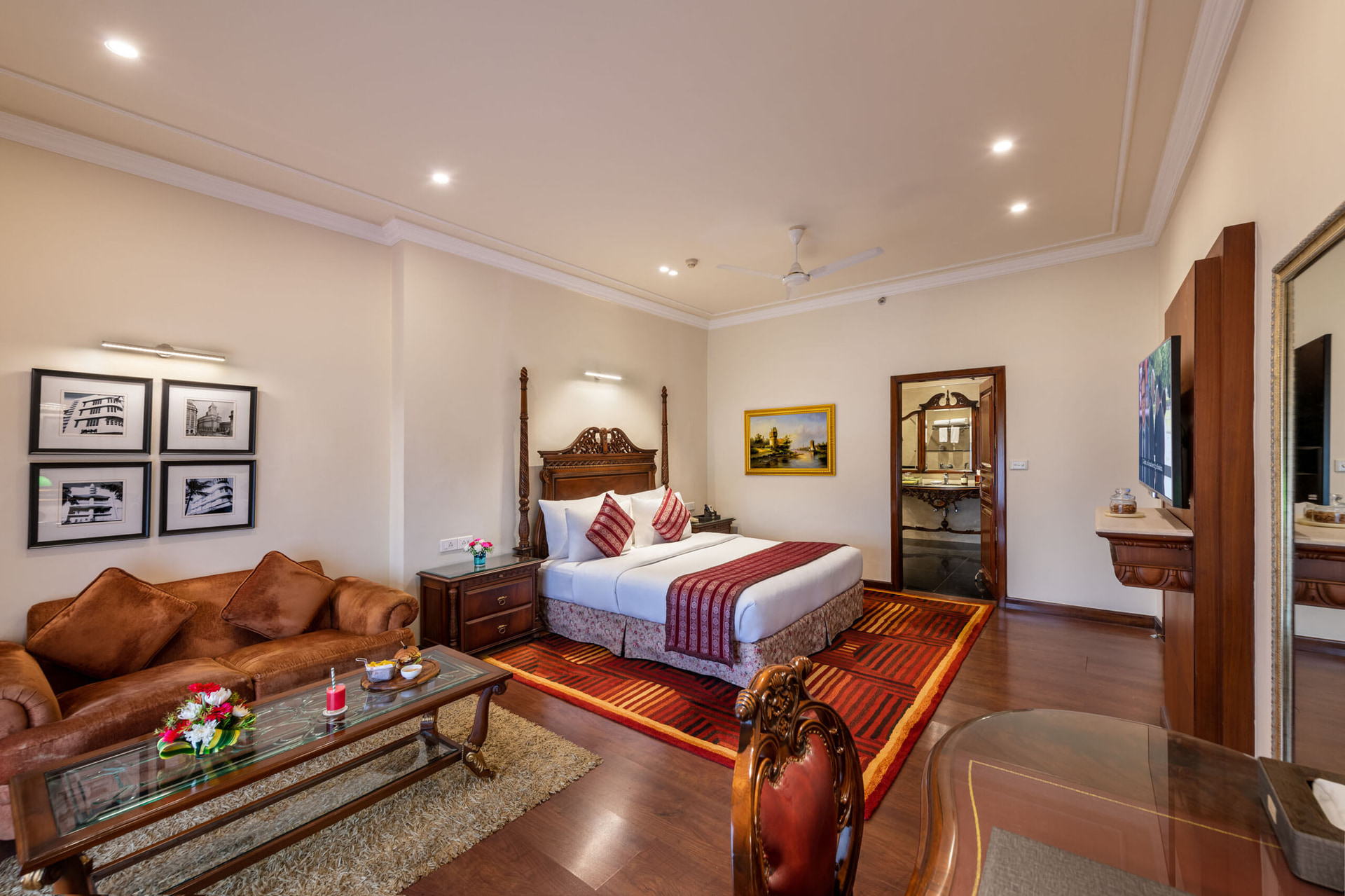 Luxurious Executive Suite at Mayfair Lagoon Bhubaneswar featuring a king-size bed, rich wooden furniture, classic artwork, and elegant warm-toned interiors