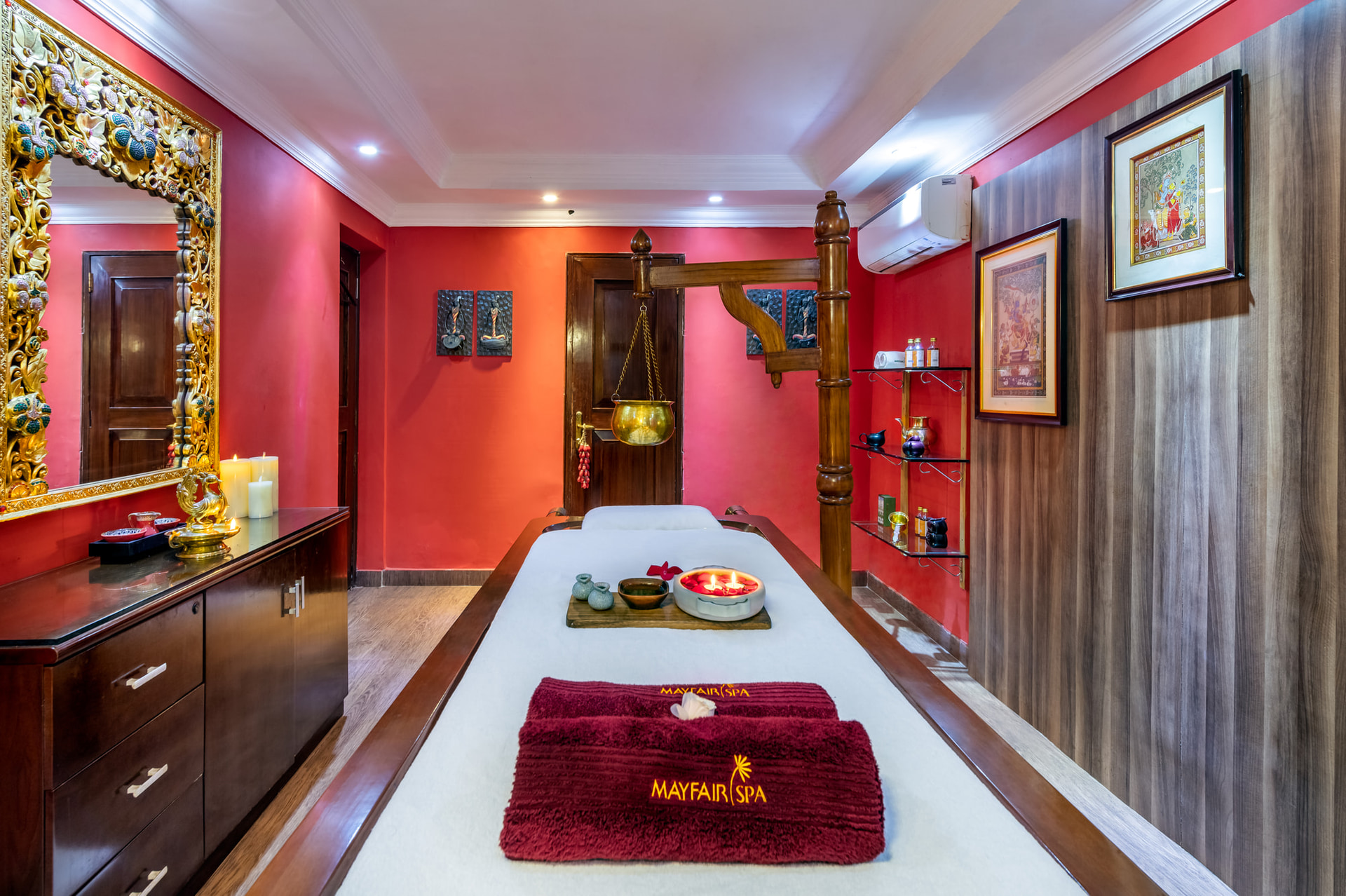 Luxurious spa treatment room with red interiors and massage bed at Mayfair Lagoon