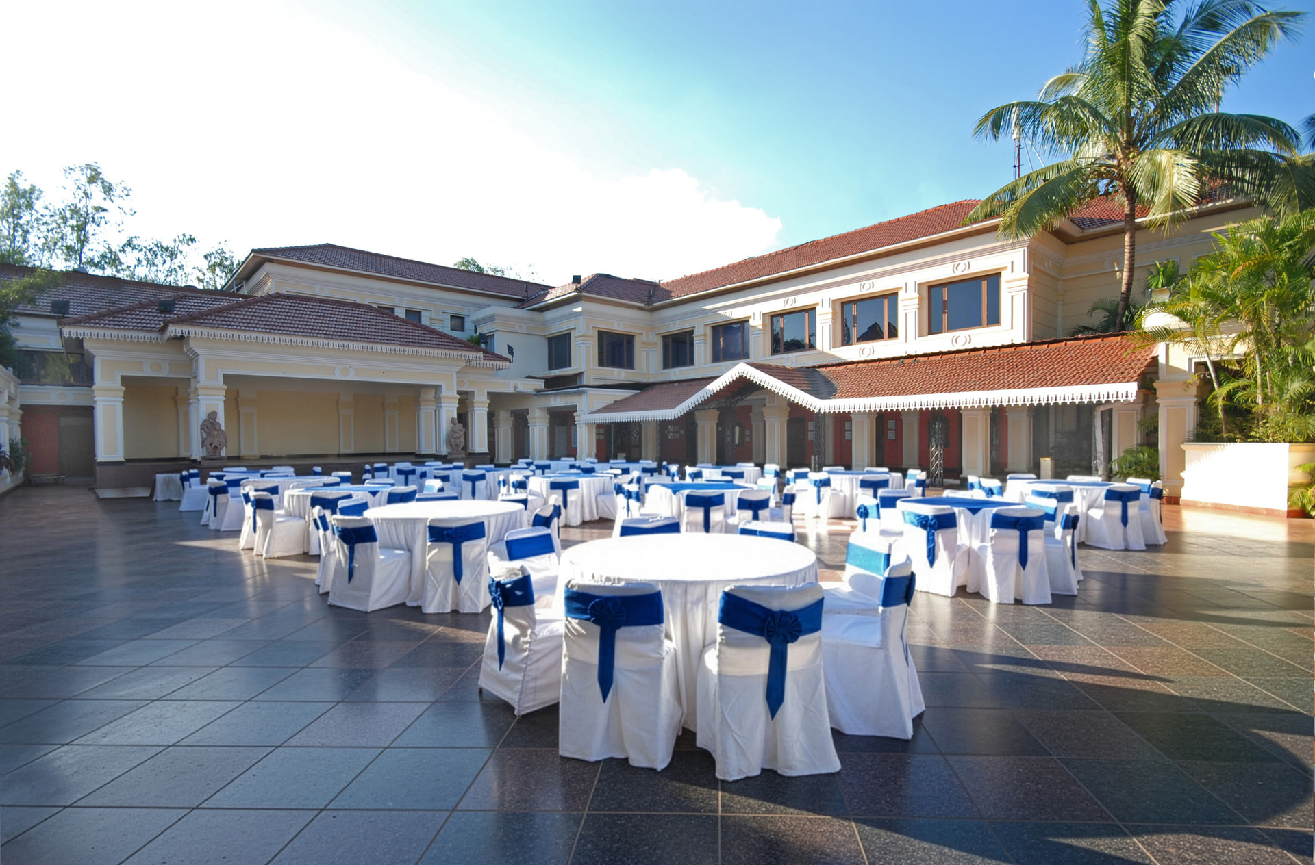 Open air wedding mandap venue at Mayfair Lagoon Bhubaneswar with white chair arrangements and tropical garden surroundings