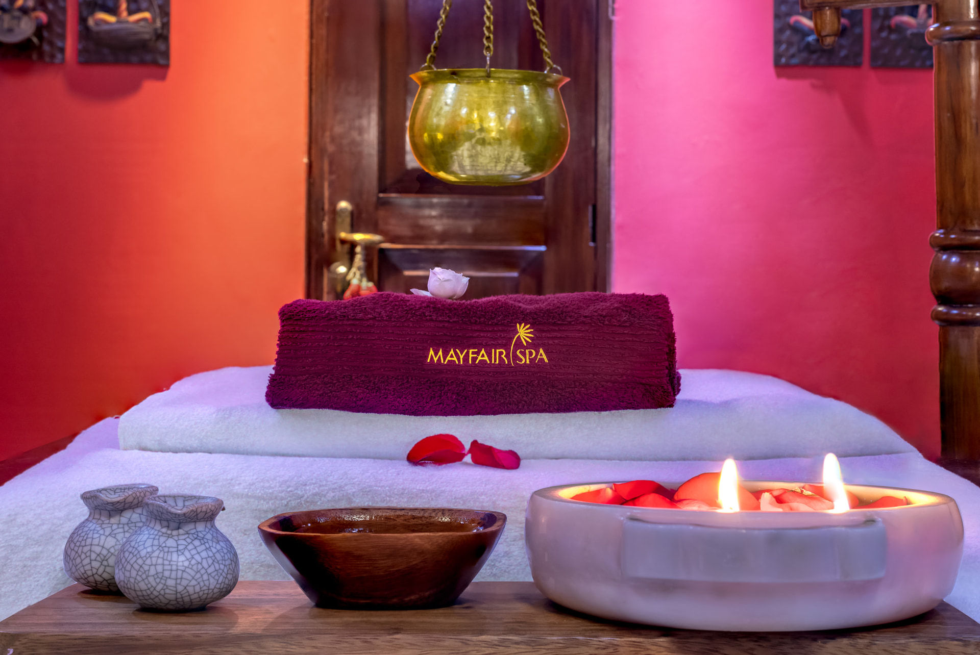 Serene spa setup with candles, flower petals and traditional decor at Mayfair Lagoon Bhubaneswar