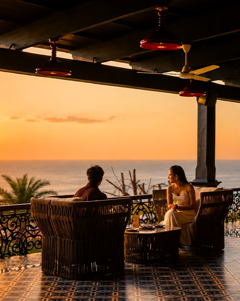 A couple watching the sunset from a terrace lounge