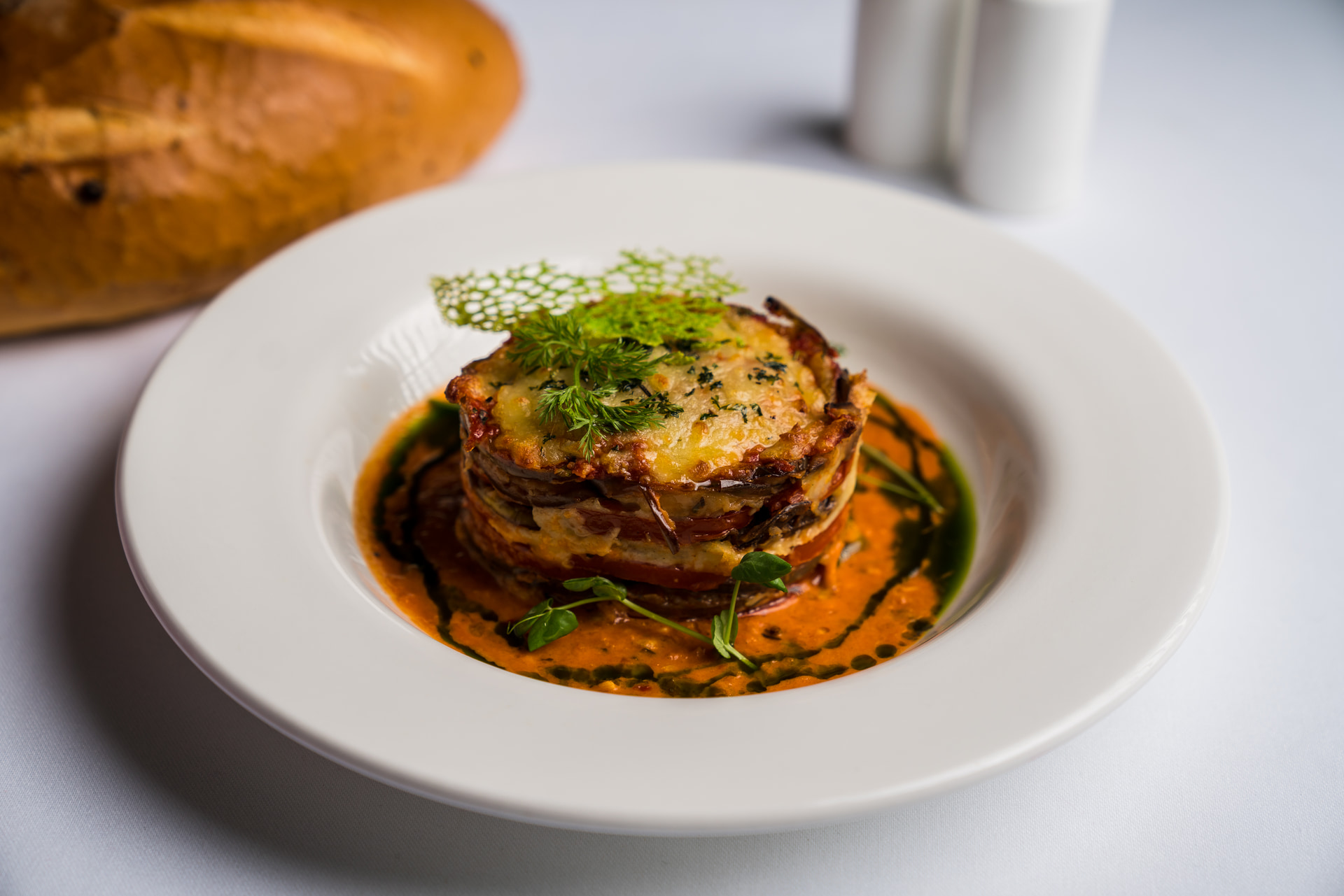 A plated course dressed with herb oil